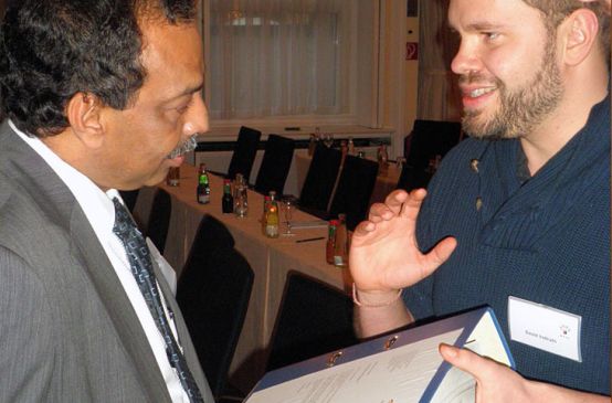 An employee of Rainforest Rescue hands over signatures to a board member of the Malaysian Palm Oil Council