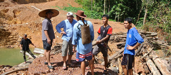 Matek (SADIA) with indigenous people at an illegal logging site