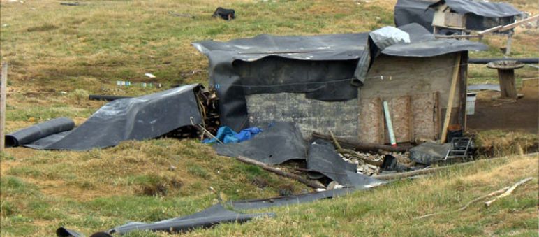 Cajamarcan infront of a fallen down hut