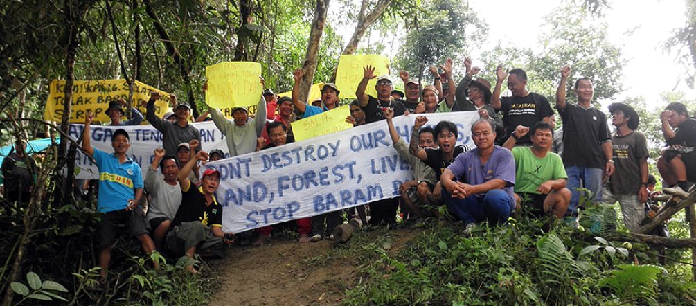 Rainforest dwellers protesting the dam projects Source: SAVE Rivers Indigenous peoples of the Sarawak rainforest protesting with banners against Baram Dam