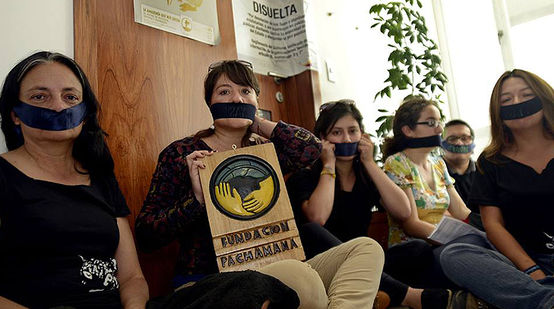 Activists with a taped mouth in Quito