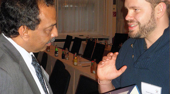 An employee of Rainforest Rescue hands over signatures to a board member of the Malaysian Palm Oil Council