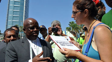 Guadalupe Rodríguez handing a petition to Motsamai Nkosi of the WFC