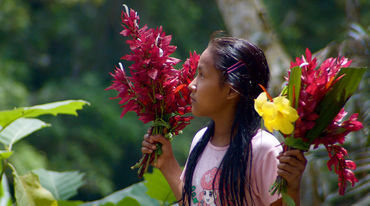 Kichwa girl with flowers in her hand in Sarayaku