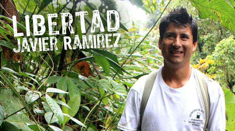 Javier Ramírez standing in front of rainforest plants