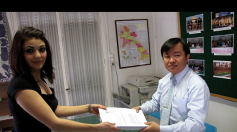 Our activist Nolwenn hands over the protest signatures to the prime secretary of the laotian consulate in Paris