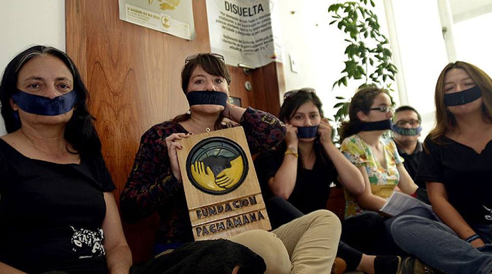 Silent protest of the environmental and human rights activists in Quito Activists with a taped mouth in Quito