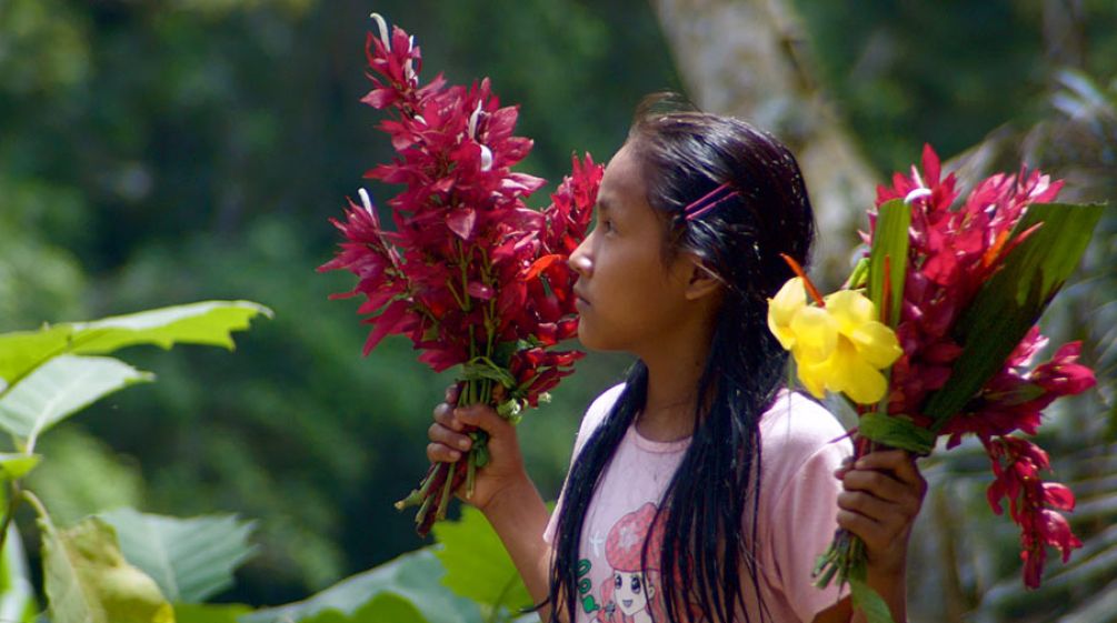 Kichwa girl with flowers in her hand in Sarayaku